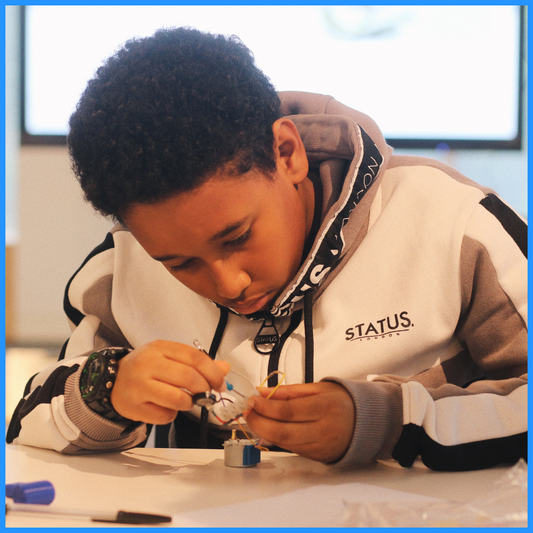 A student (one of our engineers for the day!) building a DIY flashlight.